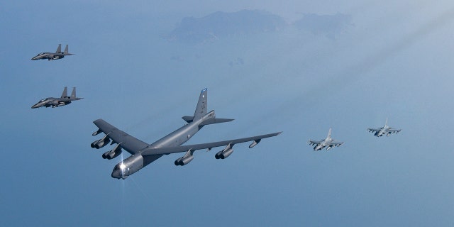 In this photo provided by South Korea Defense Ministry, a U.S. Air Force B-52H Stratofortress aircraft, center, flies in formation with South Korea's Air Force KF-16 fighters and South Korea's Air Force F-15K fighters over the western sea of Korean peninsula during a joint air drill in South Korea, Monday, March 6, 2023.