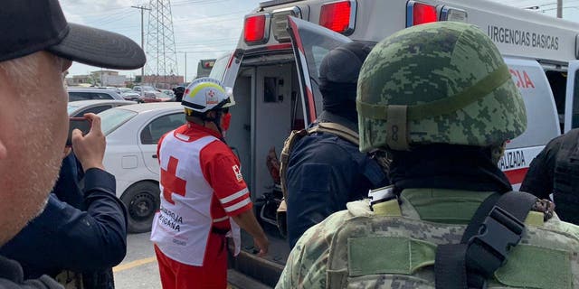 A Red Cross worker closes the door of an ambulance carrying two Americans found alive after their abduction in Mexico last week in Matamoros on March 7, 2023.