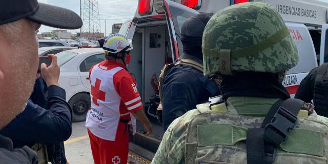 A Red Cross worker closes the door of an ambulance carrying two Americans found alive after their abduction in Mexico last week, in Matamoros, Tuesday, March 7, 2023.