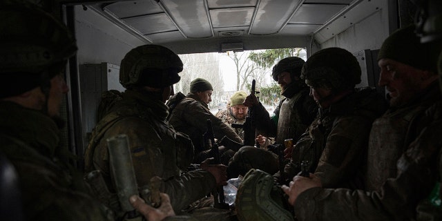 Ukrainian servicemen sit inside a van in Chasiv Yar, Ukraine, Wednesday, March 8, 2023. 