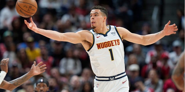 Denver Nuggets forward Michael Porter Jr. pulls in a loose ball in the first half of an NBA basketball game against the Chicago Bulls Wednesday, March 8, 2023, in Denver.
