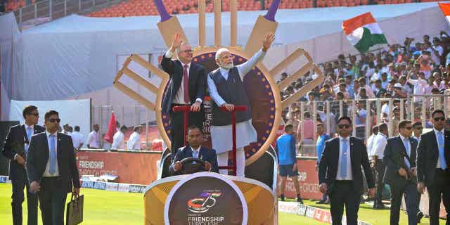 Indian Prime Minister Narendra Modi stands next to Australian Prime Minister Anthony Albanese as they arrive in the stadium to watch a cricket test match between India and Australia in Ahmedabad, India, on March 9, 2023.