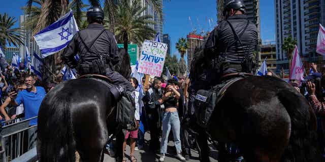 Mounted police are deployed as protestors block a main road to demonstrate against plans by Prime Minister Benjamin Netanyahu's new government to overhaul the judicial system in Tel Aviv, Israel, on March 9, 2023.