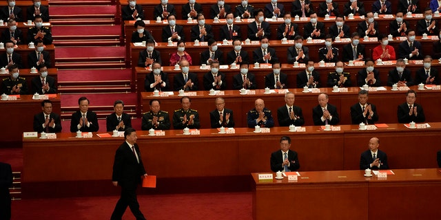 Chinese President Xi Jinping walks to vote during the session of China's National People's Congress to elect the national leader at the Great Hall of the People in Beijing.