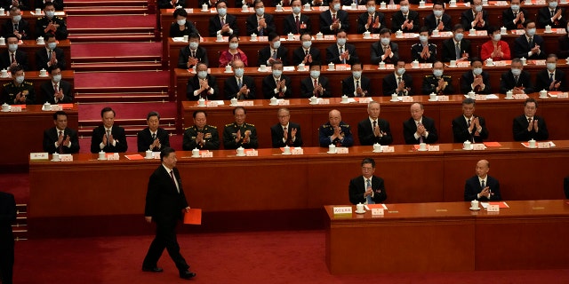 Chinese President Xi Jinping walks to cast his vote during a session of China's National People's Congress (NPC) to select state leaders at the Great Hall of the People in Beijing on Friday, March 10, 2023. 