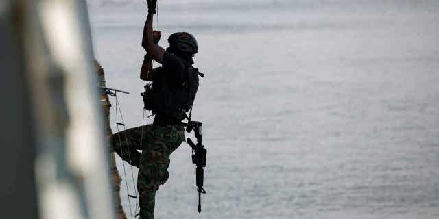A Ghanaian soldier performs hook and climb drills at Tema port, Ghana, on March 9, 2023. Around 1,300 military personnel from 29 countries in Africa are training in Ghana and Ivory Coast, amid surging jihadi violence.