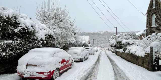 Cars covered in snow are pictured in England on March 10, 2023. The Met Office issued warnings for northern England, the Midlands, North Wales, and Northern Ireland, where "significant disruption" to transport and power supplies is expected because of the snow.