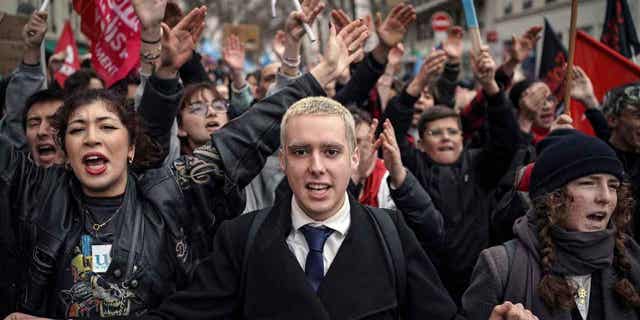 Protesters shout slogans during a demonstration in central France, on March 11, 2023. Opponents of President Emmanuel Macron's plan are staging their eight round of strikes as a committee of lawmakers and senators are set to examine the bill.