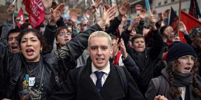 Protesters shout slogans during a demonstration in central France, on March 11, 2023. Opponents of President Emmanuel Macron's plan are staging their eight round of strikes as a committee of lawmakers and senators are set to examine the bill.