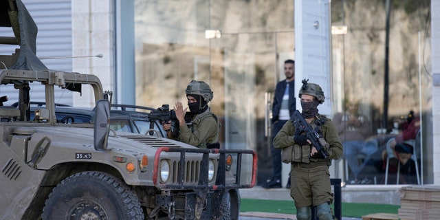 Israeli soldiers operate in the village of Sarra near the Palestinian city of Nablus in the West Bank on Sunday, March 12, 2023. 