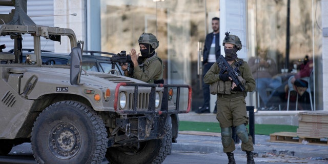 Israeli soldiers operate in the village of Sarra near the Palestinian West Bank city of Nablus, Sunday, March 12, 2023. 