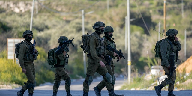 Israeli forces shot dead three Palestinian militants who opened fire on troops near the West Bank city of Nablus. 