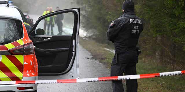 Police forces stand in a blockaded area in Freudenberg, Germany March 12, 2023. A girl went missing on Saturday and police discovered her body on Sunday.  Police took two children into custody in connection with the murder.