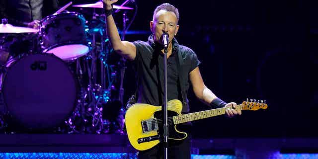 Bruce Springsteen on stage with a guitar