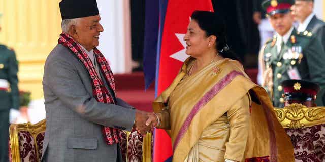 Outgoing President Bidhya Devi Bhandari, right, congratulates Nepal's newly elected president Ram Chandra Poudel, after he took the oath of office in Kathmandu, Nepal, on March 13, 2023. 