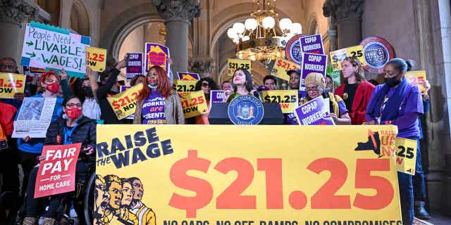 New York Sen. Jessica Ramos stands with protesters urging lawmakers to raise New York's minimum wage during a rally on March 13, 2023, in Albany, New York.