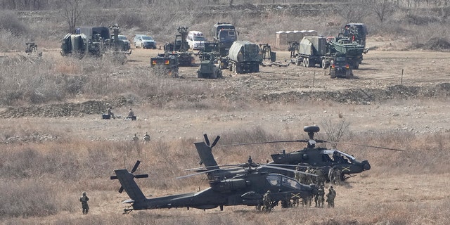 FILE - U.S. Army Apache helicopters park at a training ground in Yeongcheon, near the border with North Korea, March 13, 2023. 