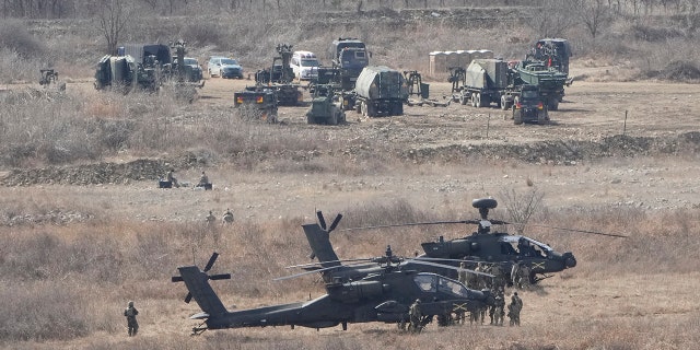 FILE - U.S. Army Apache helicopters park at a training field in Yeoncheon, near the border with North Korea on March 13, 2023. 