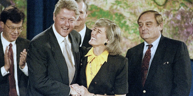 FILE - President Bill Clinton introduces Rep. Pat Schroeder, of Colorado, during a ceremony honoring community heroes from flood-afflicted states in St. Louis, on Aug. 12, 1993. 