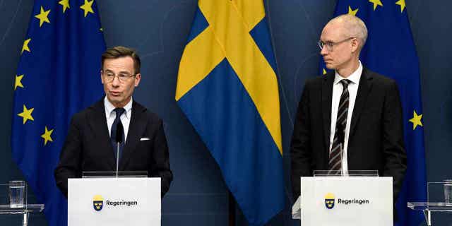 Sweden's Prime Minister Ulf Kristersson, left, and Oscar Stenstroem, ambassador in the cabinet preparation and chief negotiator in the NATO process, hold a press briefing on the NATO process in Stockholm.