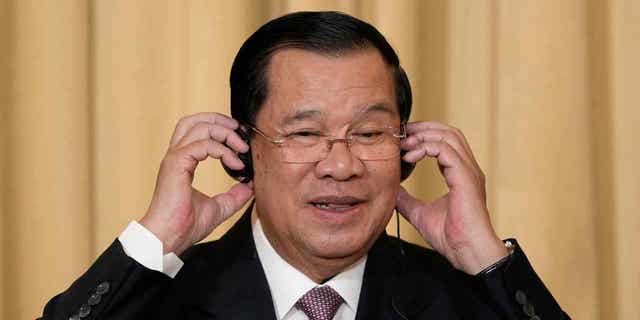 Cambodian Prime Minister Hun Sen attends a news conference at the Elysee Palace in Paris December 13, 2022. Two Cambodian activists were accused of insulting the king and prime minister on social media.