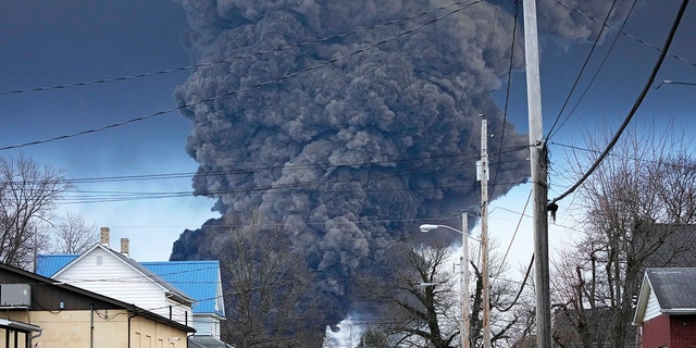 A black plume rises over East Palestine, Ohio, as a result of a controlled detonation of a portion of the derailed Norfolk Southern trains, Feb. 6, 2023. 