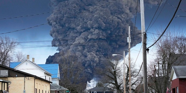 A black plume rises over East Palestine, Ohio, as a result of a controlled detonation of a portion of the derailed Norfolk Southern trains, Feb. 6, 2023. 