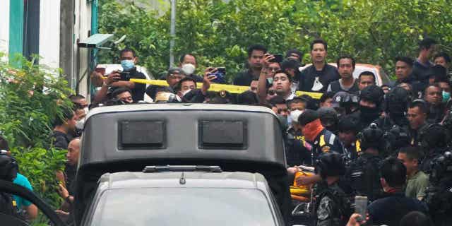 A senior police officer is carried on to an ambulance in Bangkok, Thailand, on March 15, 2023. Thai police detained the senior police officer who fired multiple gunshots from his home in Bangkok during a standoff.
