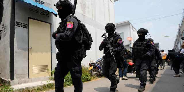 Thai police to be subjected to random physical, mental health checks after standoff with officer 2 A group of police officers leave the home of a senior police officer in Bangkok, Thailand, on March 15, 2023. Thai police have arrested the officer after he fired multiple gunshots from his home. Due to the incident, Thai officers will be subjected to random physical and mental health evaluations.