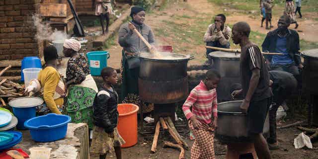 Community volunteers prepare meals for people who were displaced following tropical Cyclone Freddy in Blantyre, southern Malawi, on March 16, 2023. In Cyclone Freddy's aftermath, southern Africa has been warned of potential landslides and floods near Malawi and Mozambique.