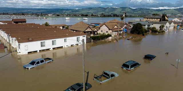 Floodwaters surround homes in the community of Pajaro in Monterey County, California, on March 13, 2023. Record snowfall and rain have helped to ease the droughts in the western United States. Reservoir and groundwater storage levels in some parts of the country remain historically low.