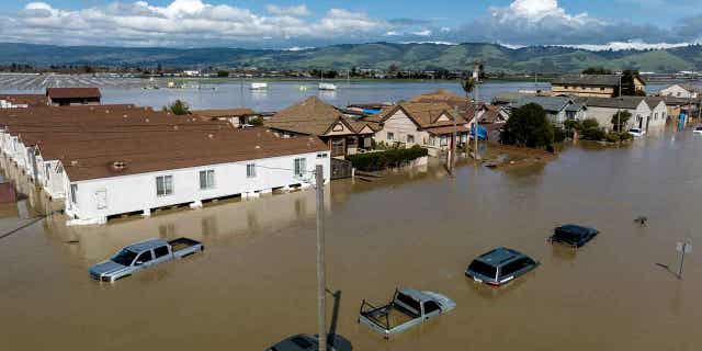 Floodwaters surround homes in the community of Pajaro in Monterey County, California, on March 13, 2023. Record snowfall and rain have helped to ease the droughts in the western United States. Reservoir and groundwater storage levels in some parts of the country remain historically low.