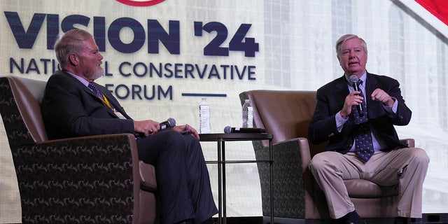Sen. Lindsey Graham, R-S.C., right, speaks at the Vision '24 conference on March 18, 2023, in North Charleston, S.C., as Palmetto Family board chairman Tony Beam looks on.