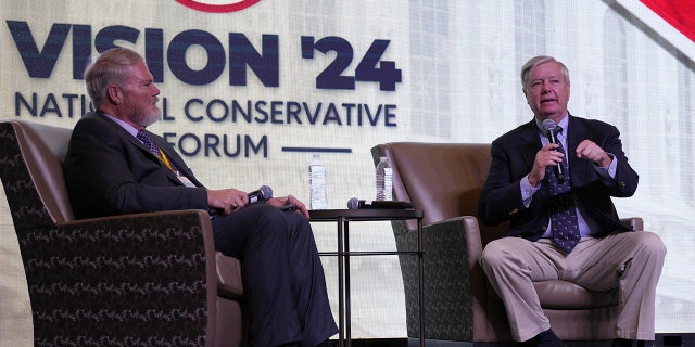 Sen. Lindsey Graham, R-S.C., right, speaks at the Vision '24 conference on March 18, 2023, in North Charleston, S.C., as Palmetto Family board chairman Tony Beam looks on.