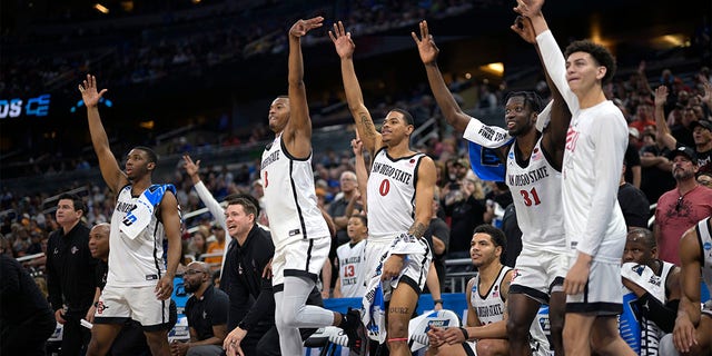 San Diego State players celebrate a teammate's three-pointer at the end of the second half of a second-round college basketball game against Furman in the NCAA Tournament, Saturday, March 18, 2023, in Orlando, Florida . 