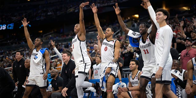 San Diego State players celebrate a teammate's 3-pointer late in the second half of a second-round college basketball game against Furman in the NCAA Tournament, Saturday, March 18, 2023, in Orlando, Fla.
