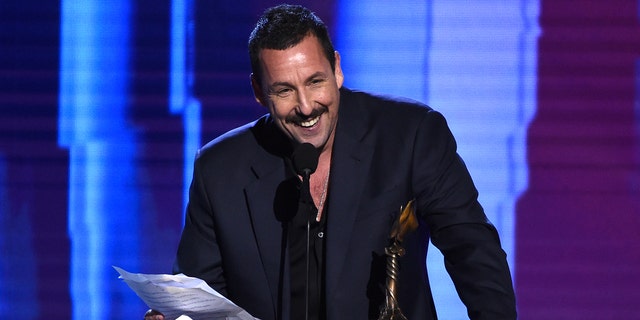 FILE - Adam Sandler accepts the award for best male lead for "Uncut Gems" at the 35th Film Independent Spirit Awards on Feb. 8, 2020, in Santa Monica, Calif. 