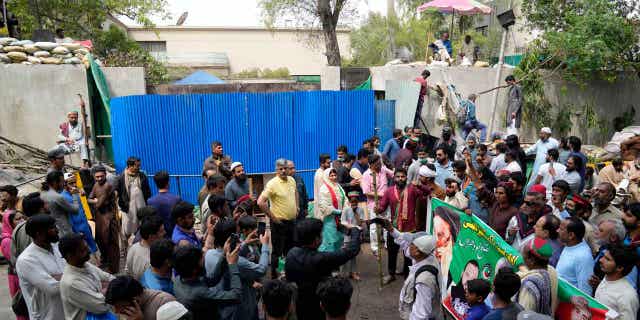 Supporters of former Prime Minister Imran Khan gather outside the Khan house in Lahore, Pakistan, on March 19, 2023.  Scores of Kahn supporters were arrested for attacking officers over the weekend.