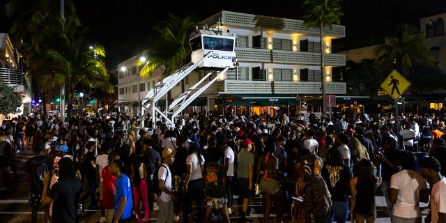 Crowds gather at Ocean Drive and 8th during spring break on Saturday, March 18, 2023, in Miami Beach, Fla.