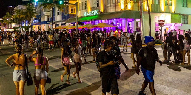 Crowds walk up and down Ocean Drive during spring break on Saturday, March 18, 2023, in Miami Beach, Fla. 