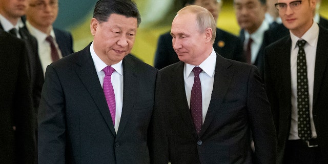 FILE - Chinese President Xi Jinping, left, and Russian President Vladimir Putin enter a hall for talks in the Kremlin in Moscow, Russia, June 5, 2019. 