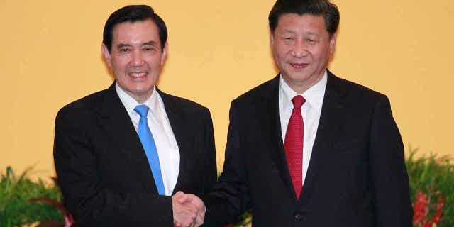 Taiwan's former President Ma Ying-jeou, left, and China's President Xi Jinping shake hands on Nov. 7, 2015, in Singapore. Former Taiwan President Ma will visit China next week to ease tension in the region.