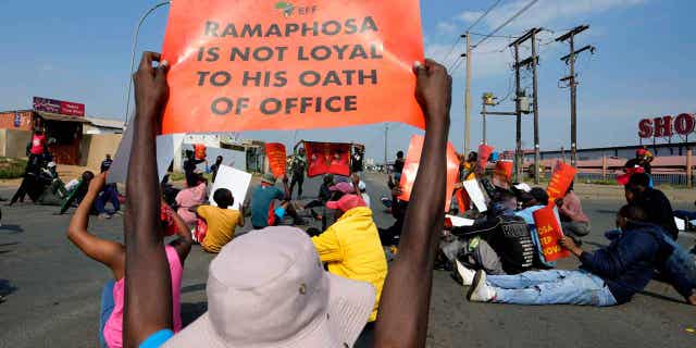 Economic Freedom Fighters members protest on the street in Tsakane township, South Africa, on March 20, 2023. South African police deployed in major cities on Monday ahead of planned anti-government protests by the leftist Economic Freedom Fighters party. 