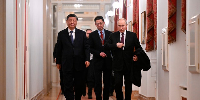 Chinese President Xi Jinping, left, and Russian President Vladimir Putin walk after their talks at the Kremlin in Moscow on March 20, 2023. 