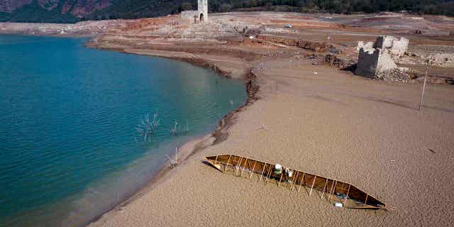 The Sau reservoir in Spain is pictured on March 20, 2023. The Sau reservoir's water levels now stand at nine percent of total capacity, so officials have taken the decision to remove its fish to prevent them from asphyxiating.