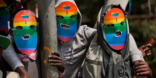 Kenyan gays and lesbians and others supporting their cause wear masks to preserve their anonymity in Nairobi, Kenya on Feb. 10, 2014. 