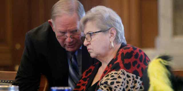 Kansas House Speaker Dan Hawkins, left, confers with state Rep. Brenda Landwehr ahead of a House debate on a proposed "born-alive infants protection," law to apply to abortion providers on March 21, 2023. Landwehr is chair of the House health committee that worked on the measure, which would require providers to try to preserve the lives of infants born during unsuccessful abortions.