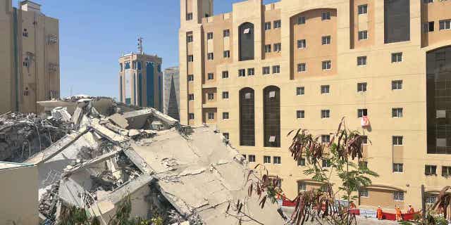 The ruins of a collapsed building are seen in Doha, Qatar, on March 22, 2023. At least one person has been confirmed dead following the collapse.