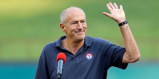 Texas Rangers radio sports announcer Eric Nadel waves to cheering fans as he emcees a pregame ceremony honoring Adrian Beltre before a baseball game against the New York Yankees on Friday, Sept. 8, 2017, in Arlington, Texas.