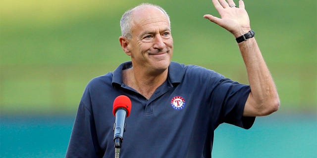 Texas Rangers radio sports announcer Eric Nadel waves to cheering fans as he emcees a pregame ceremony honoring Adrian Beltre before a baseball game against the New York Yankees on Friday, Sept. 8, 2017, in Arlington, Texas.